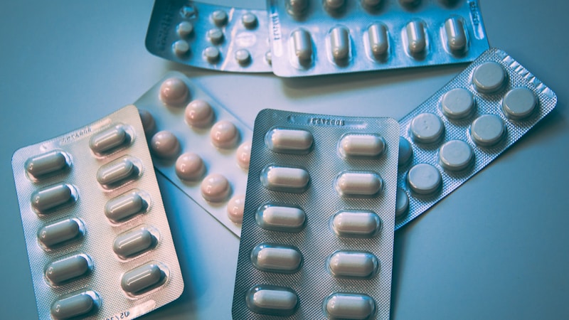 Rows of prescription medication bottles on hospital pharmacy shelving