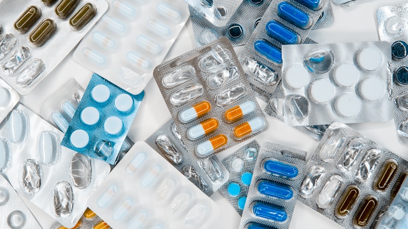 Hospital pharmacy technician reviewing medication inventory on a computer screen